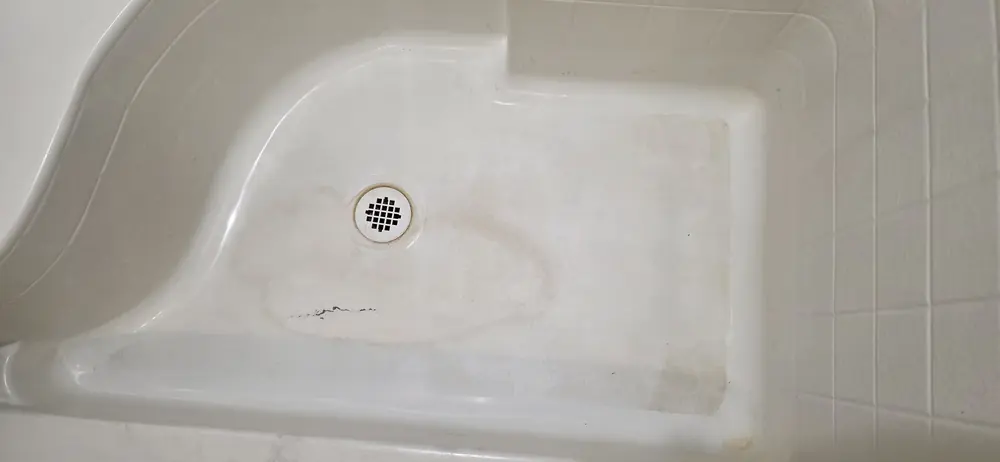Cracked shower floor before repair